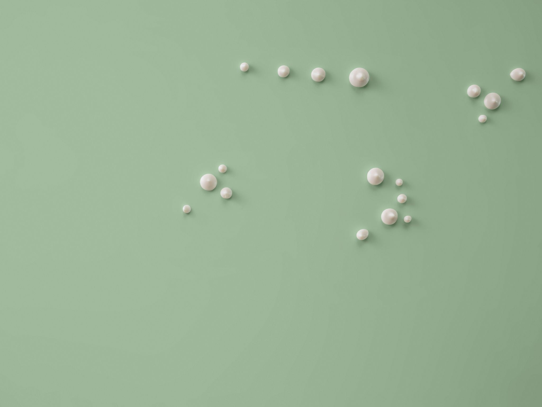 grüner Hintergrund mit Cremetropfen